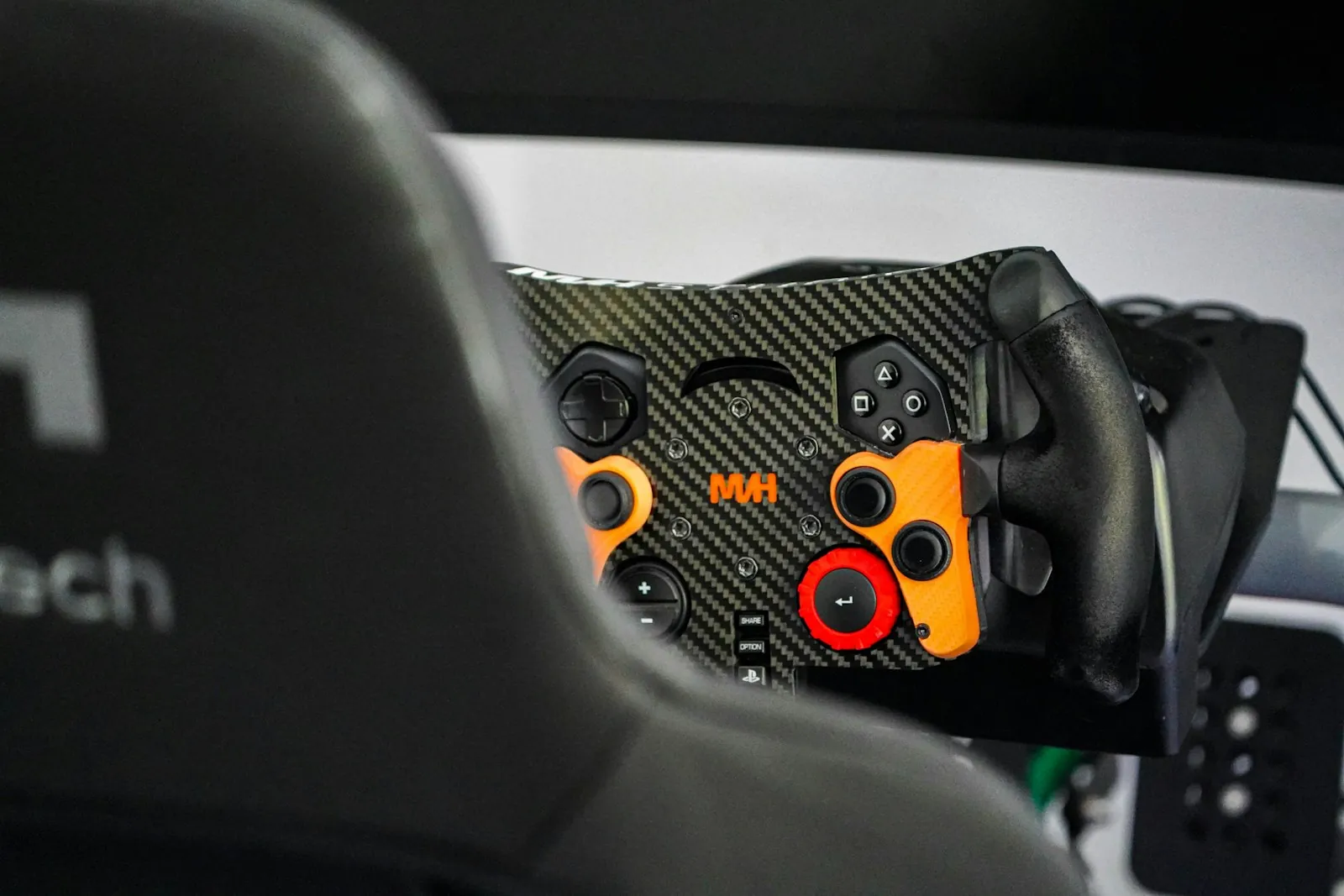 Close up of a button laden sim racing wheel mounted on a rig