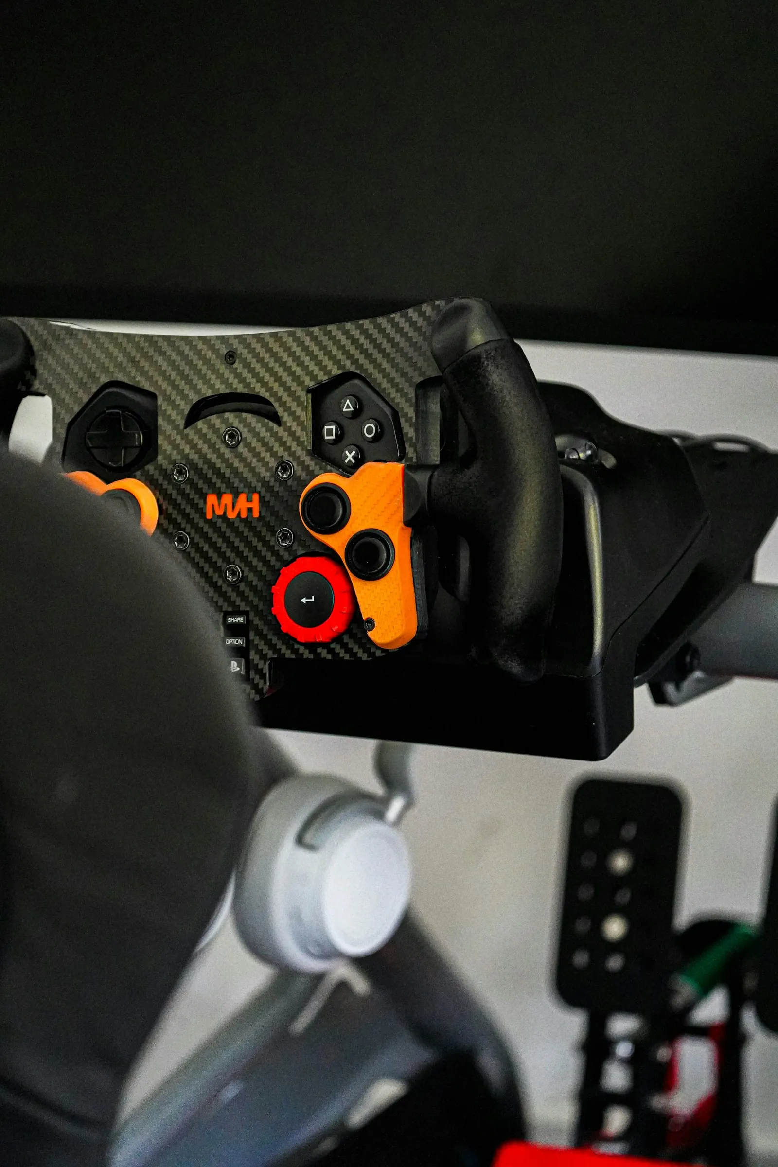 Sim racing wheel and pedal set mounted on a cockpit rig
